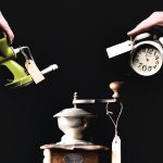 the poster of the show. three old objects are seen: a coffee grinder, an alarm clock and a mincer. each has a tag on it. the latter two are held by hands